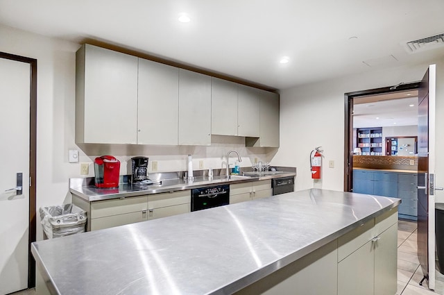 kitchen featuring dishwasher, stainless steel counters, and light tile patterned floors