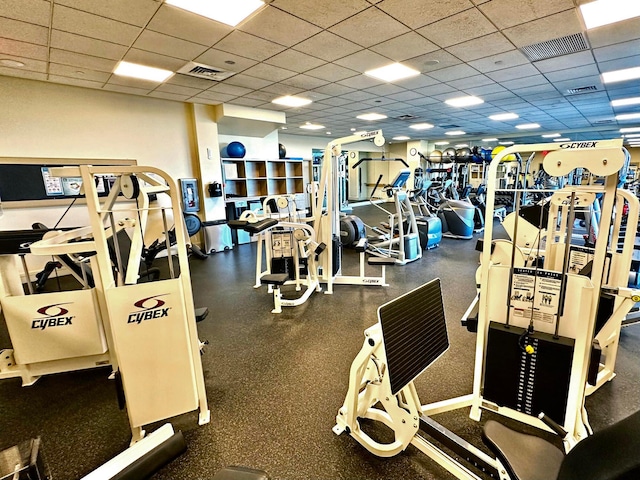 gym with a paneled ceiling