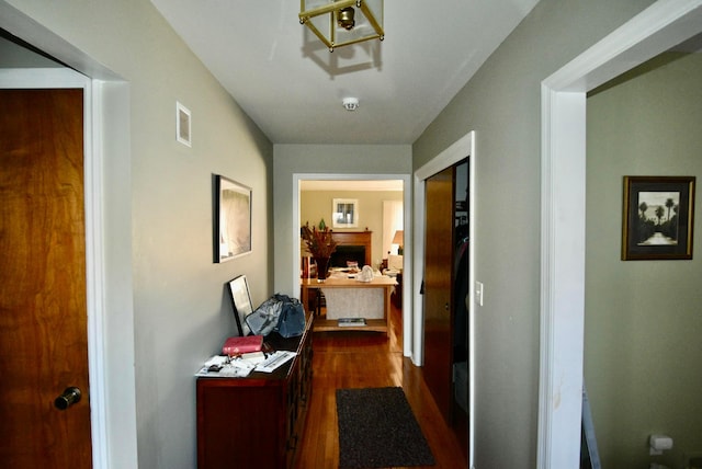 corridor with dark hardwood / wood-style flooring