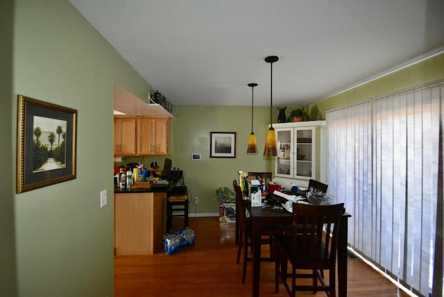 dining space with dark hardwood / wood-style flooring