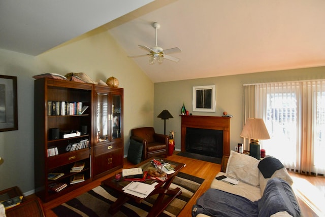 living room featuring vaulted ceiling, ceiling fan, and light hardwood / wood-style floors