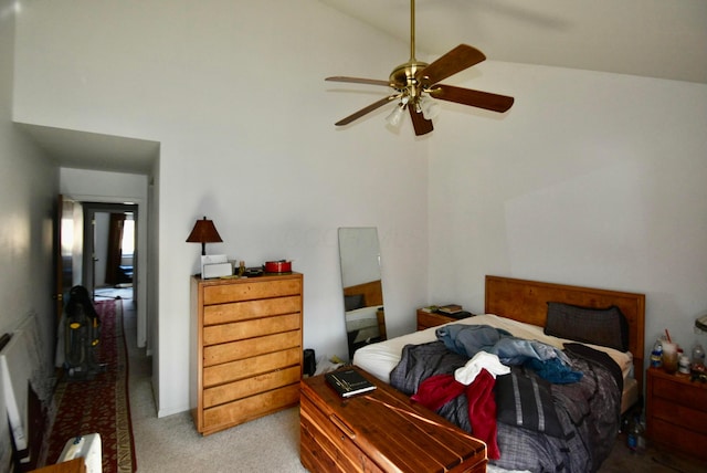 carpeted bedroom with ceiling fan and vaulted ceiling