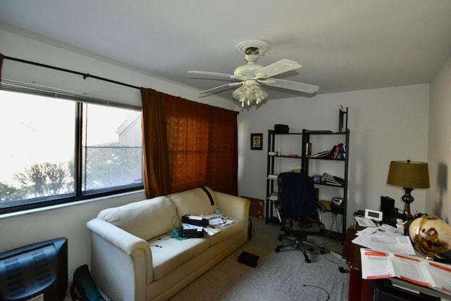 carpeted office space with ceiling fan