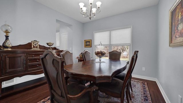 dining room with hardwood / wood-style floors and a chandelier