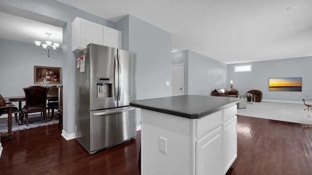 kitchen with stainless steel refrigerator with ice dispenser, white cabinetry, an inviting chandelier, a center island, and dark hardwood / wood-style flooring