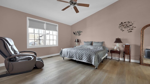 bedroom featuring ceiling fan, lofted ceiling, and light wood-type flooring