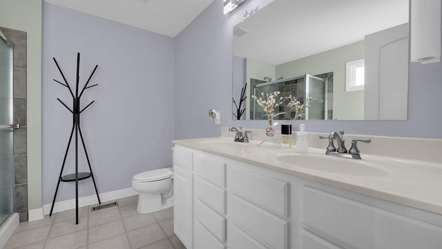 bathroom featuring vanity, toilet, an enclosed shower, and tile patterned flooring