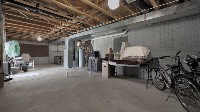 basement with water heater and brick wall