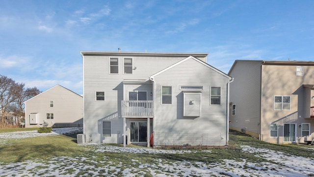 snow covered property featuring central AC