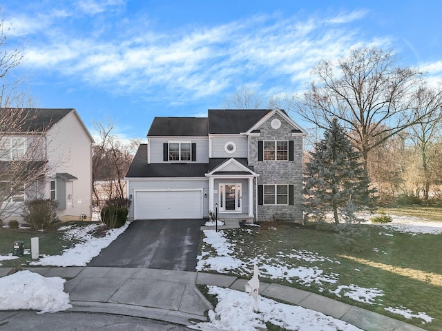 front of property featuring a yard and a garage