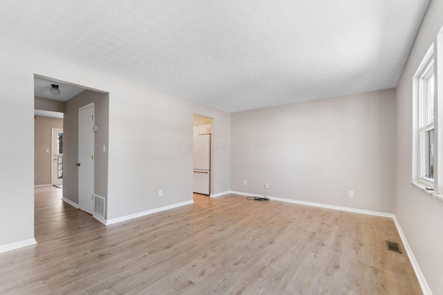 unfurnished room with light wood-type flooring