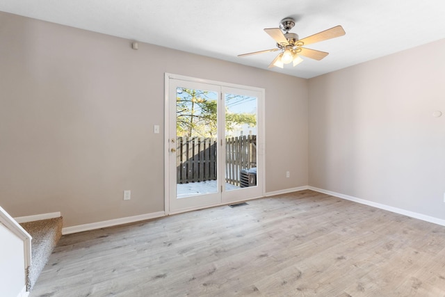 spare room featuring light hardwood / wood-style flooring and ceiling fan