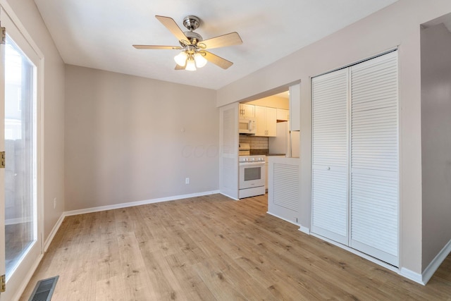 unfurnished living room with light hardwood / wood-style floors and ceiling fan