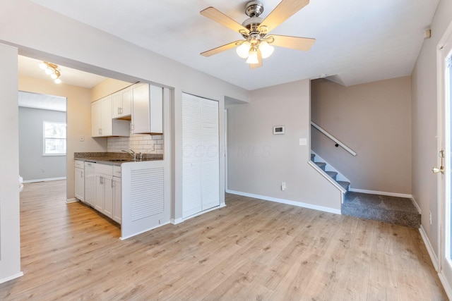 kitchen featuring sink, white cabinetry, ceiling fan, light hardwood / wood-style floors, and decorative backsplash