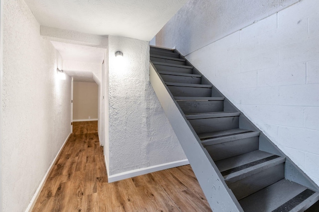 stairs featuring wood-type flooring