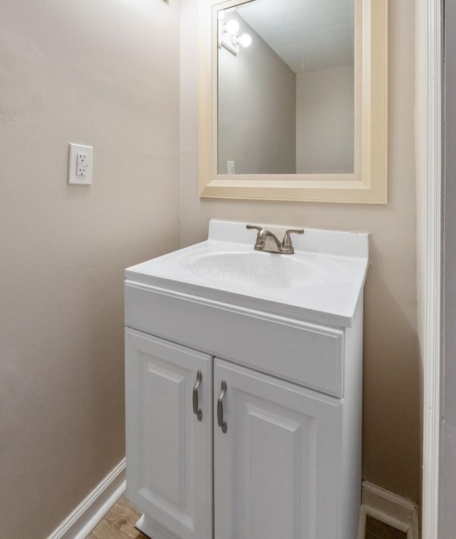 bathroom with vanity and hardwood / wood-style flooring