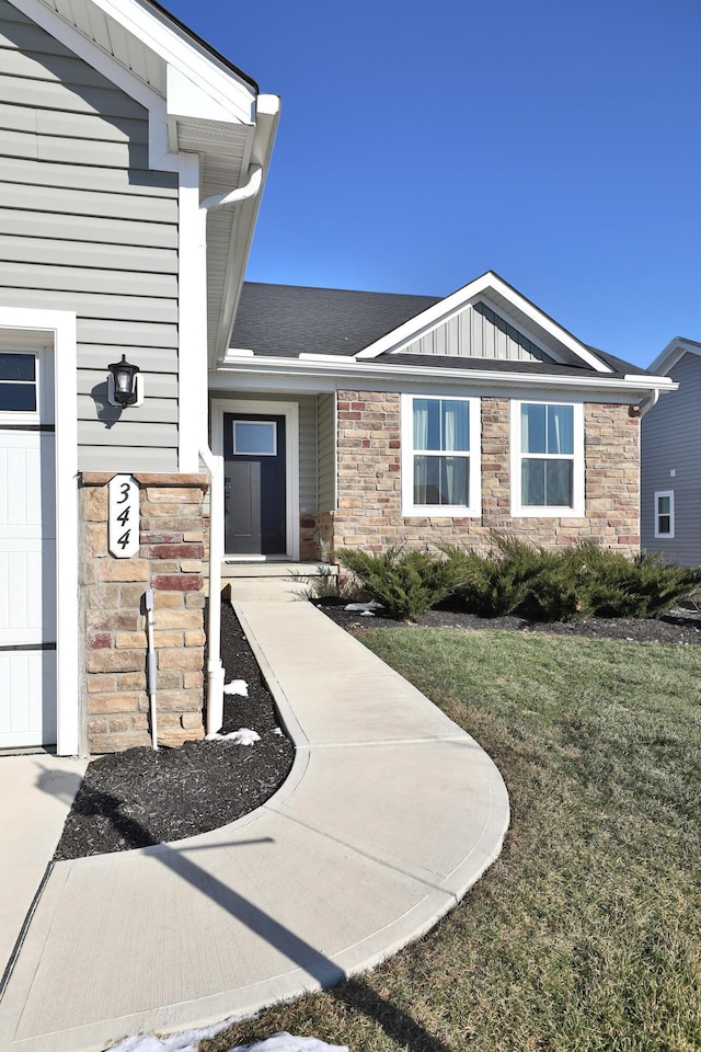 property entrance with a lawn