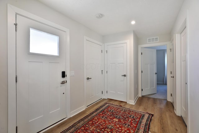 foyer entrance with light hardwood / wood-style floors