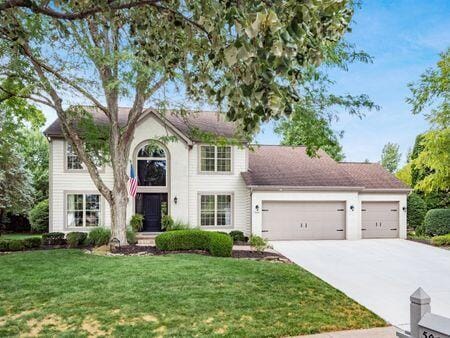 view of front of house with a garage and a front yard