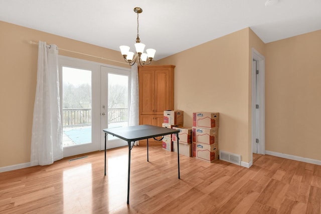 playroom featuring a notable chandelier, light hardwood / wood-style floors, and french doors