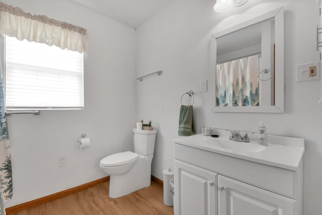 bathroom with vanity, toilet, and hardwood / wood-style floors