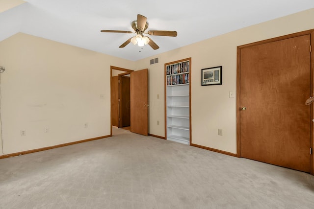 unfurnished bedroom with light colored carpet and ceiling fan