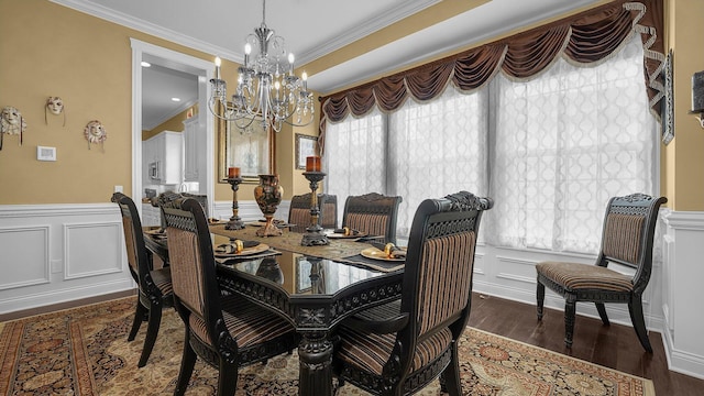 dining room with dark wood-type flooring, crown molding, and a notable chandelier