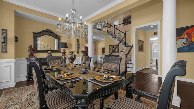 dining space with ornate columns, crown molding, dark hardwood / wood-style floors, and a notable chandelier