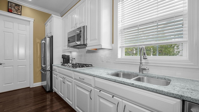 kitchen featuring light stone counters, sink, white cabinets, and appliances with stainless steel finishes