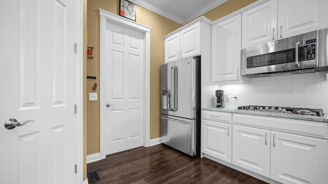 kitchen featuring appliances with stainless steel finishes, dark hardwood / wood-style floors, white cabinets, backsplash, and crown molding