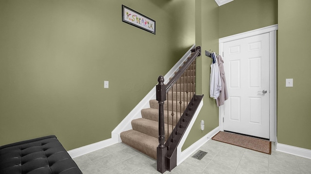 stairway featuring tile patterned flooring