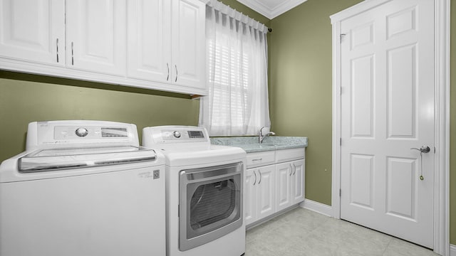 laundry room featuring light tile patterned flooring, sink, crown molding, cabinets, and separate washer and dryer