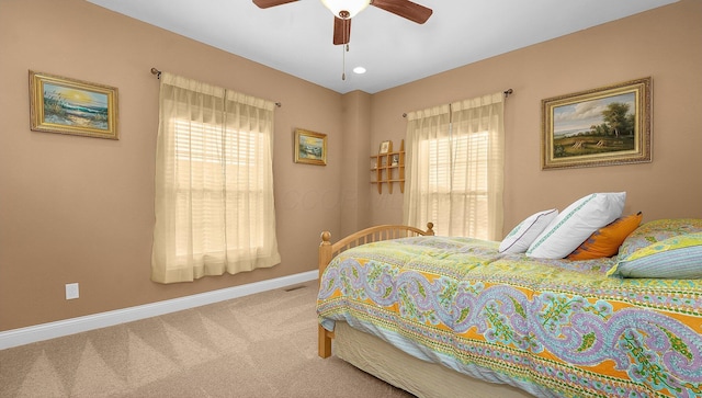 bedroom with light carpet and ceiling fan