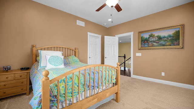 bedroom with light colored carpet and ceiling fan