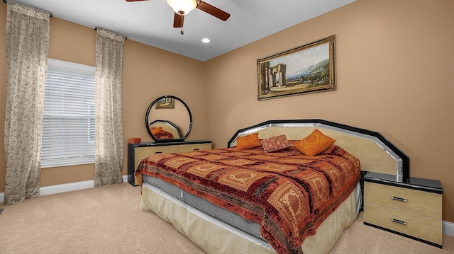 bedroom with ceiling fan and light carpet