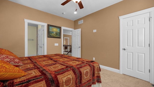 bedroom featuring ensuite bathroom, carpet, and ceiling fan