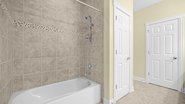 bathroom featuring tiled shower / bath combo and tile patterned floors