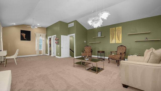 living room featuring lofted ceiling, carpet flooring, and ceiling fan with notable chandelier