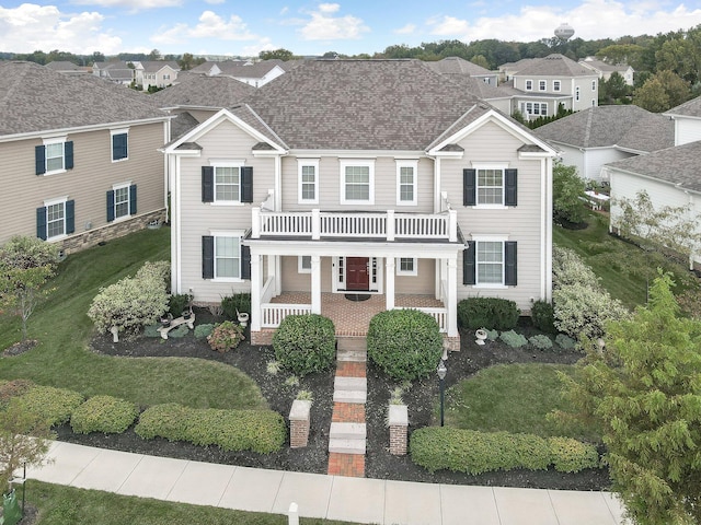 view of front of home with a balcony and a porch