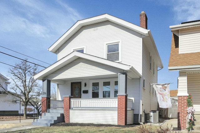 view of front of home with a porch and cooling unit