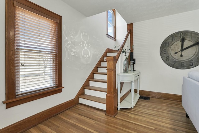 stairway featuring hardwood / wood-style floors