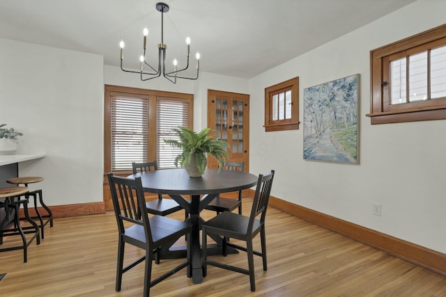 dining space with an inviting chandelier and light wood-type flooring