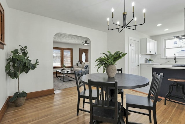 dining area featuring ceiling fan, a wealth of natural light, and light wood-type flooring