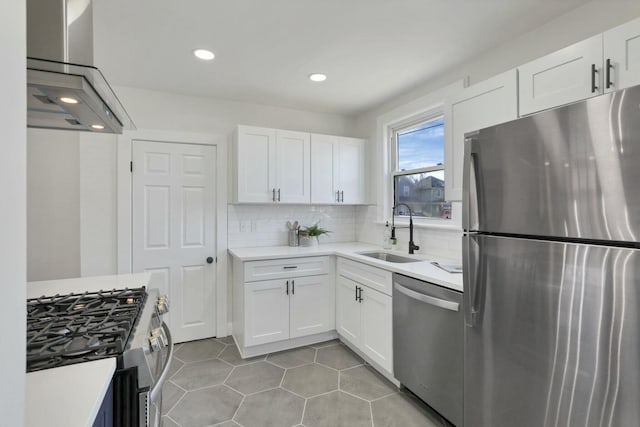 kitchen with sink, island range hood, stainless steel appliances, and white cabinets