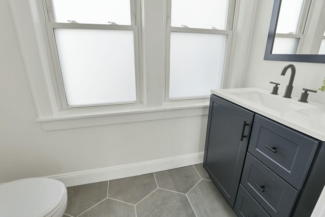 bathroom featuring vanity, tile patterned floors, and toilet