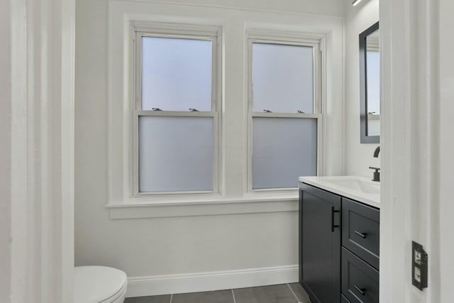 bathroom featuring vanity, tile patterned flooring, plenty of natural light, and toilet