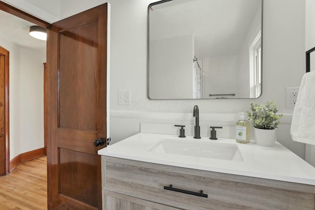 bathroom with hardwood / wood-style flooring and vanity