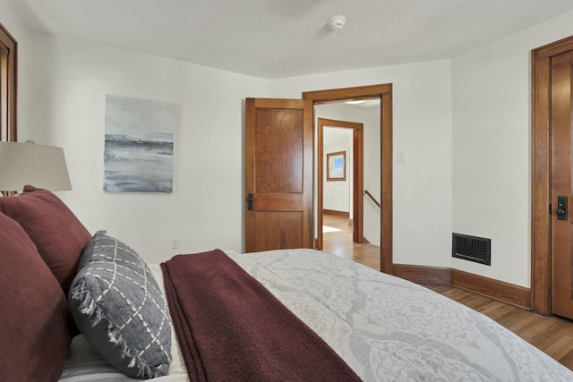 bedroom with hardwood / wood-style floors