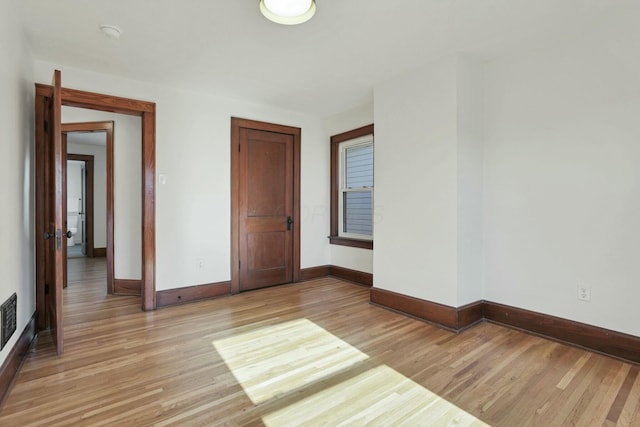 spare room featuring light hardwood / wood-style flooring