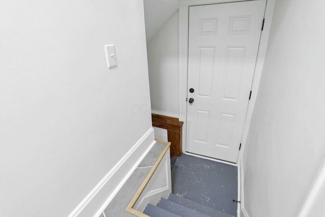 staircase featuring concrete flooring